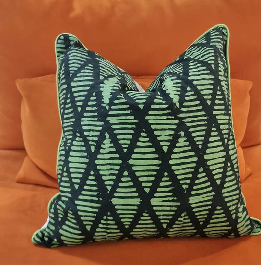 Diamond Green square cushion on orange sofa. Home 